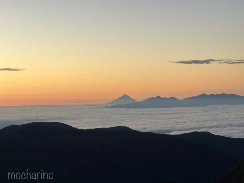 槍ヶ岳山荘から見た雲海に浮かぶ富士山の写真。